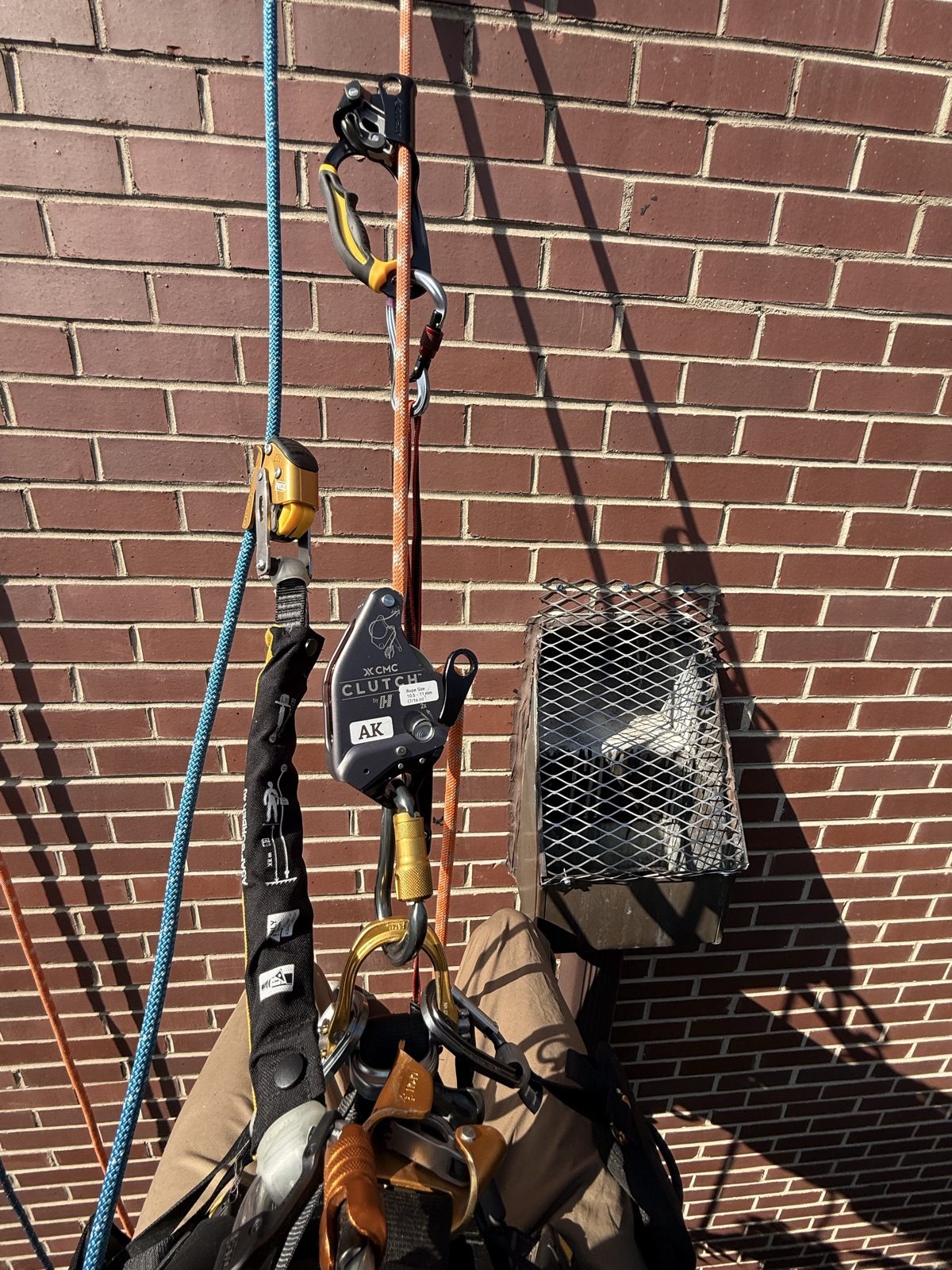 Finished stainless steel downspout bird screen after rope access installation, Old Town, Chicago